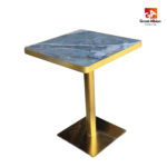 Teal green marble dining table with gold edge for upscale hospitality spaces.