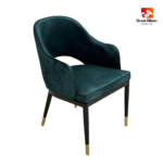 Modern velvet dining chair with stitched detailing and sophisticated black legs accented by gold caps.