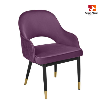 Velvet stitched dining chair with curved barrel back and elegant gold-tipped wooden legs.